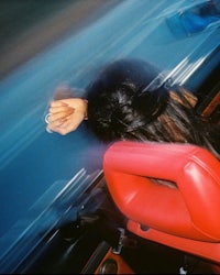 a blurry image of a woman in a car